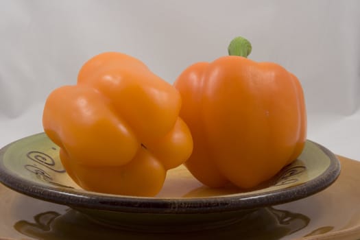 Orange peppers on a plate waiting for the salad
