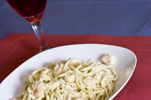 white plate full of shrimp pasta seasoned and hot