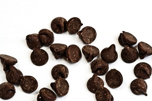 tasty chocolate chips on a white background