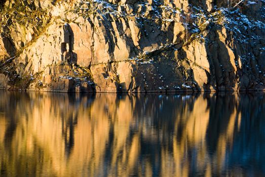 Rock and their reflection in the water in winter setting (Sweden)