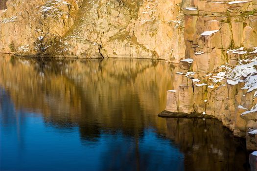 Rock and their reflection in the water in winter setting (Sweden)