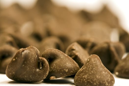 tasty chocolate chips on a white background