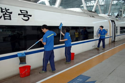 GUANGZHOU, CHINA - SEPTEMBER 29: China invests in fast and modern railway, trains with speed over 340 km/h. Washing cars before travel on September 29, 2010 in newly build Guangzhou South station.