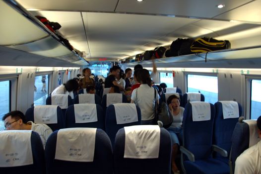 GUANGZHOU, CHINA - SEPTEMBER 29: China invests in fast and modern railway, trains with speed over 340 km/h. Passengers inside the train on the way from Guangzhou to Wuhan on September 29, 2010.