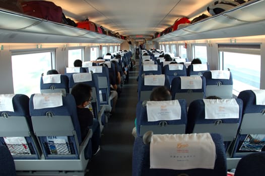 GUANGZHOU, CHINA - SEPTEMBER 29: China invests in fast and modern railway, trains with speed over 340 km/h. Passengers inside the train on the way from Guangzhou to Wuhan on September 29, 2010.