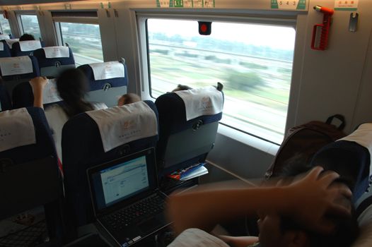 GUANGZHOU, CHINA - SEPTEMBER 29: China invests in fast and modern railway, trains with speed over 340 km/h. Passengers inside the train on the way from Guangzhou to Wuhan on September 29, 2010.
