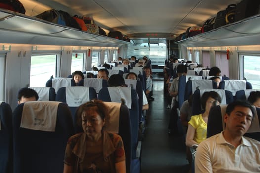 GUANGZHOU, CHINA - SEPTEMBER 29: China invests in fast and modern railway, trains with speed over 340 km/h. Passengers inside the train on the way from Guangzhou to Wuhan on September 29, 2010.