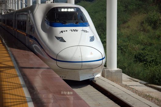 YUEYANG - HUNAN, CHINA - OCTOBER 3: China invests in fast and modern railway, trains with speed over 340 km/h. Modern train approaches station on October 3, 2010 in YueYang station.