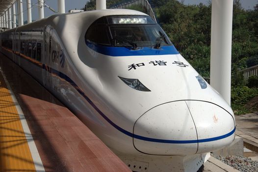YUEYANG - HUNAN, CHINA - OCTOBER 3: China invests in fast and modern railway, trains with speed over 340 km/h. Modern train approaches station on October 3, 2010 in YueYang station.