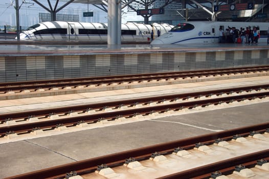 CHANGSHA - HUNAN, CHINA - OCTOBER 3: China invests in fast and modern railway, trains with speed over 340 km/h. Newly build station with trains on platforms on October 3, 2010 in Changsha.