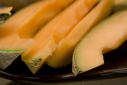 Close up shot of cantaloupe (muskmelon) cut up and laying on a plate