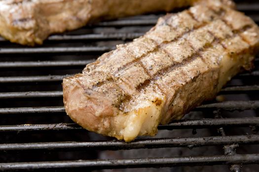 Juicy Steak cooking on the grill close up shot 