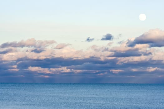 moon over cloudy waves on a big lake