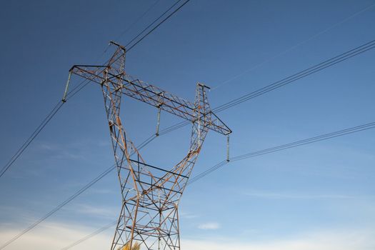 High-voltage power lines against the sky. Industrial background for appropriate purposes