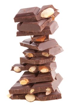 Pieces of milk chocolate with whole hazelnut lined stack. Isolated on white background