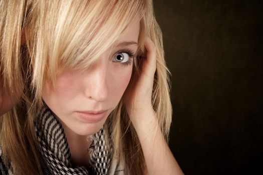 Close up of blonde girl focusing on her eye
