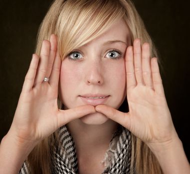 Pretty teenager framing her face with hands