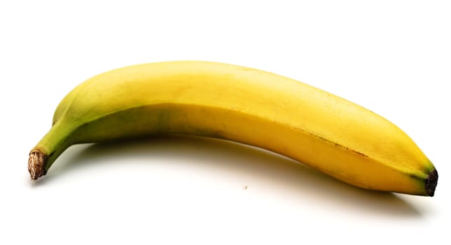 The ripe banana isolated on a white background. Light shade.