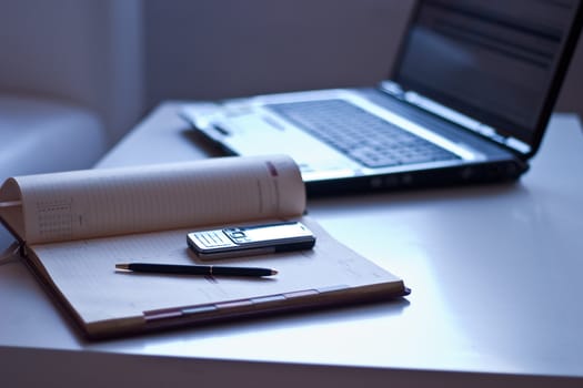 Business still-life. In the office: a laptop, notebook, mobile phone.