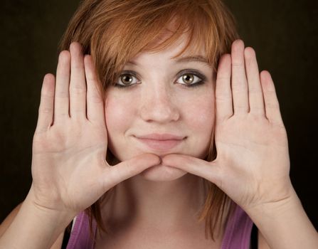 Pretty teenager framing her face with hands