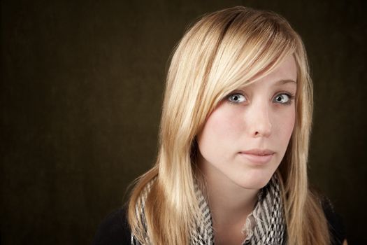 Close up of blonde girl focusing on her blue eyes
