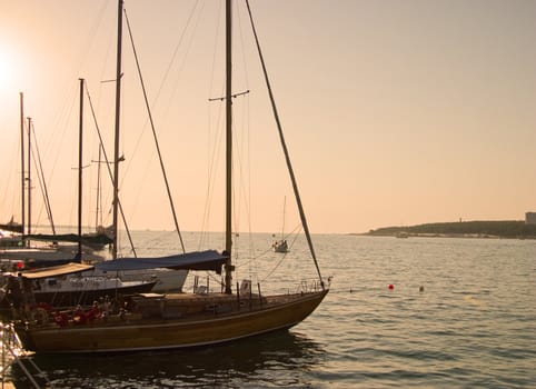Marine yachts at a pier. Sunset soft lighting.