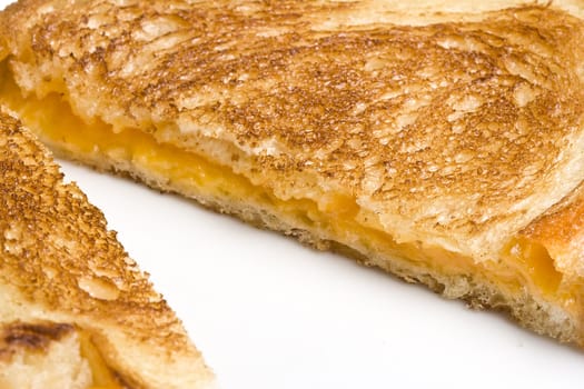 grilled cheese sandwich on a white plate shot with a macro lens