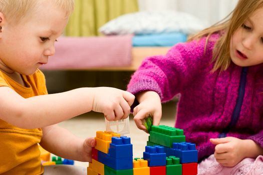 Children are jointly building a toy house
