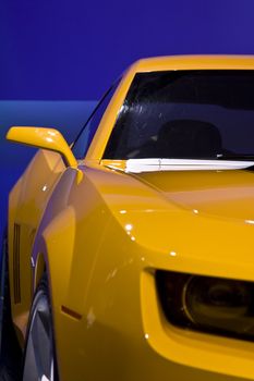 yellow sports car on a blue background