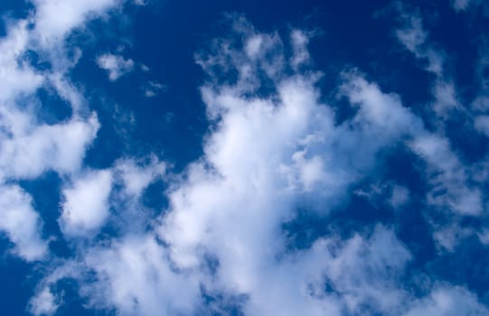 The bright blue sky with clouds