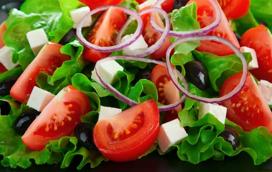 Greek salad with tomatoes cheese, herbs, olives and onions
