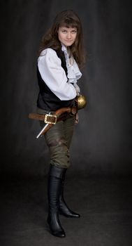 The girl - pirate with a sabre in hands on a black background