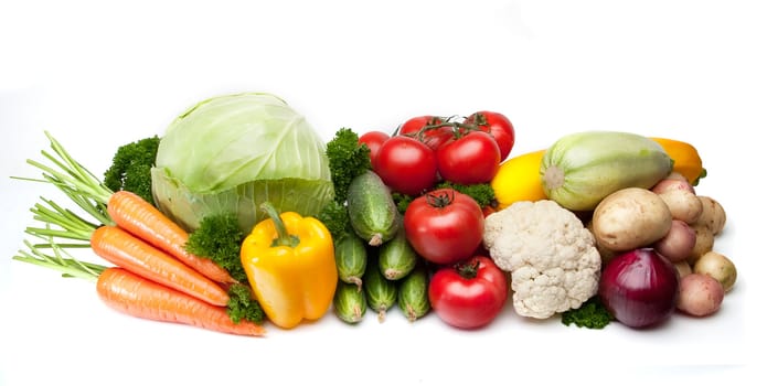 Group of vegetables: cabbage, parsley, carrots, tomatoes, cucumbers, potatoes, onions and squash. Isolated on a white background, light shade.