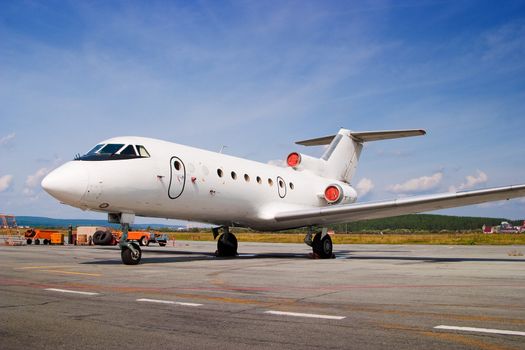 Airplane parked at airport. Small business jet.