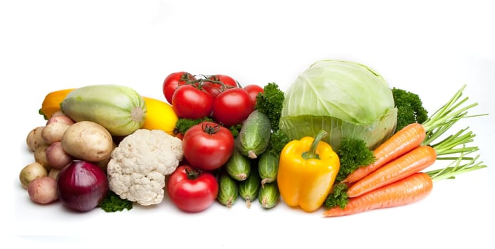 Group of vegetables: cabbage, parsley, carrots, tomatoes, cucumbers, potatoes, onions and squash. Isolated on a white background, light shade.