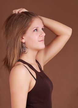 portrait of a young caucasian woman, brown background