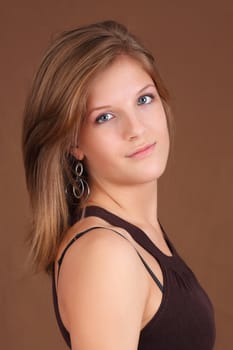 portrait of a young caucasian woman, brown background