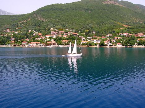 White sailing boat over blue adriatic sea in montenegro
