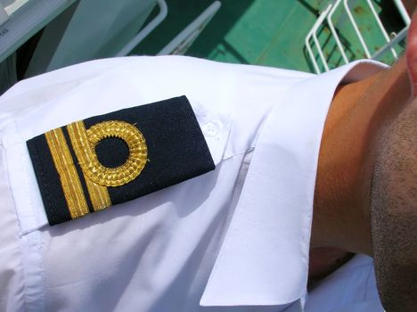 black epaulet on shoulder with gold tracks closeup
