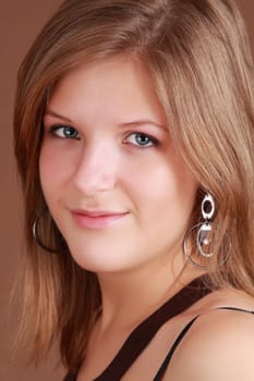 portrait of a young caucasian woman, brown background