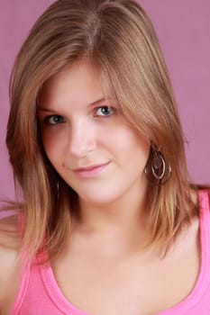 portrait of a young caucasian woman, pink background