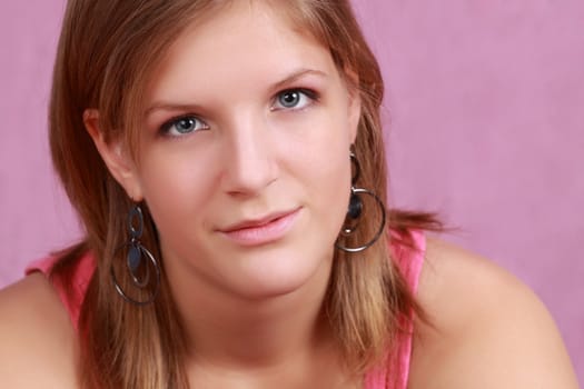 portrait of a young caucasian woman, pink background