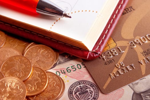 Business still-life: a pen, a diary and money
