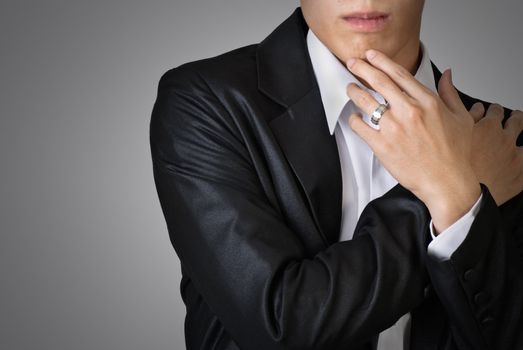 Sexy pose of business man over studio gray background.