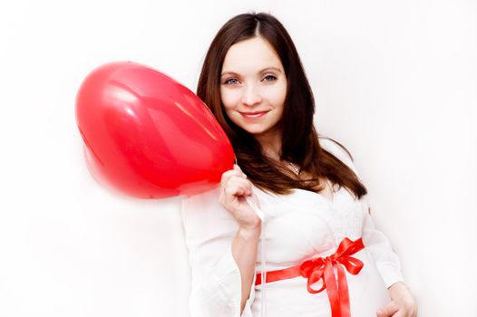 Pregnant woman with heart shaped balloon