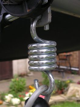 large spring being used on a hammock in a garden