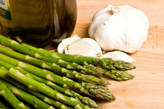 fresh asparagus and garlic on a cutting board healthy