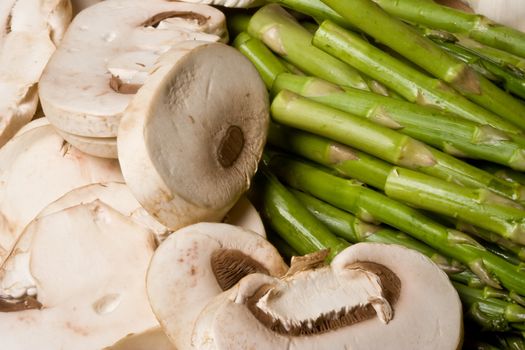 fresh mushrooms and asparagus on a cutting board healthy