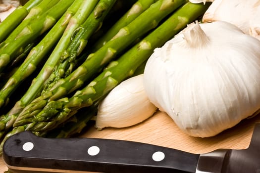 fresh asparagus and garlic on a cutting board healthy