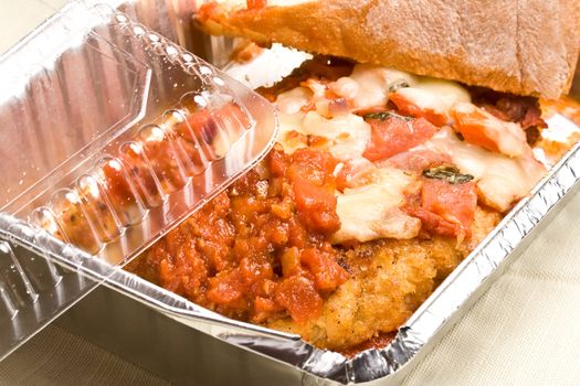 carry out meal chicken parmesan with a slice of bread in the carry out container